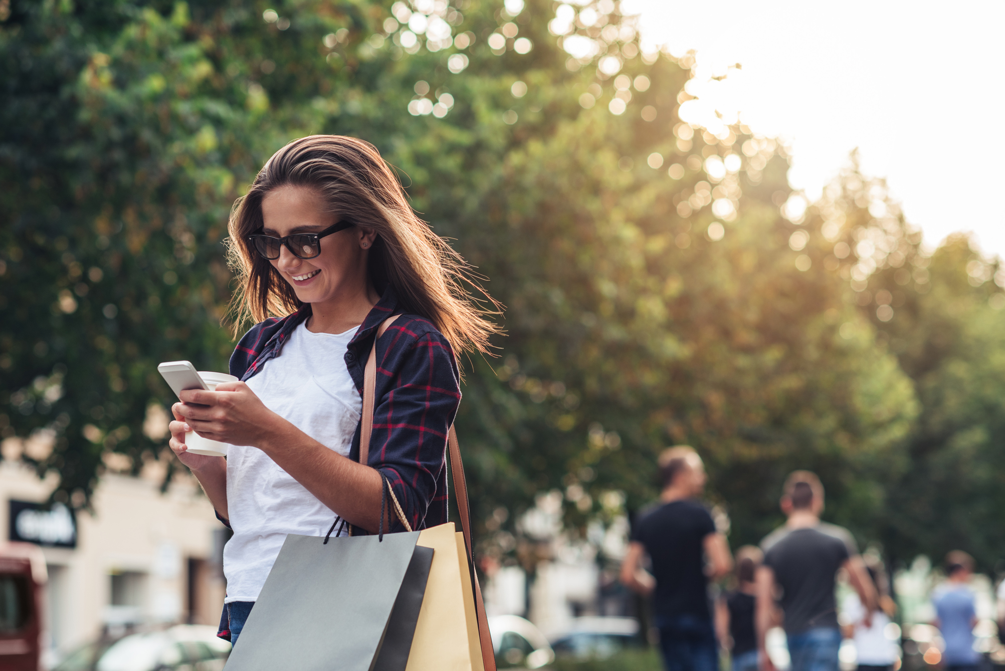 Young,Woman,Texting,While,Enjoying,A,Day,Shopping